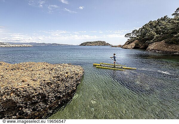 Man paddleboarding in sea