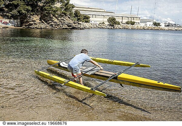 Man paddleboarding in sea