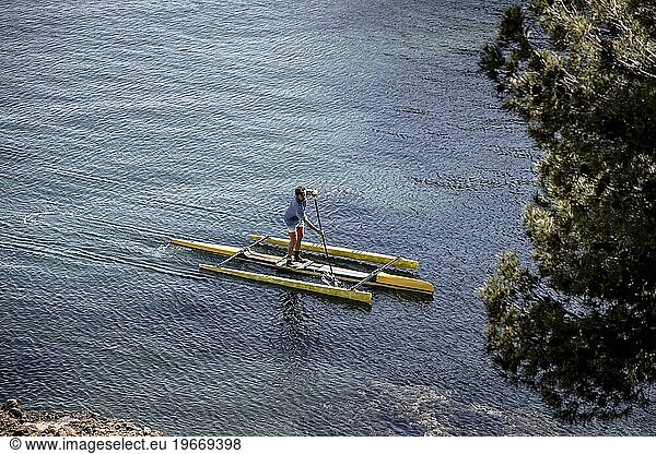 Man paddleboarding in sea