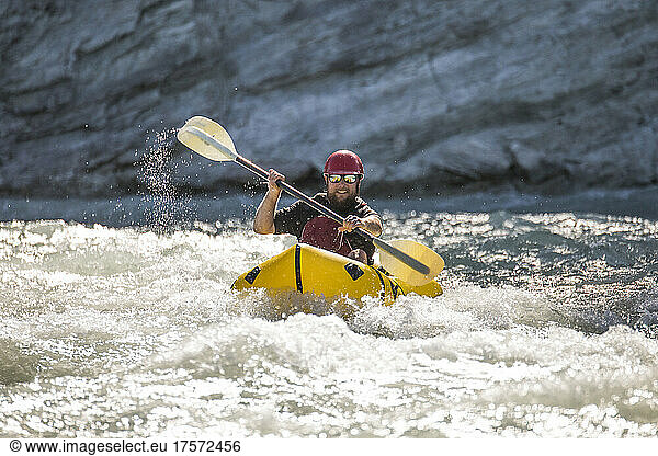 Man paddles through white water on the Kootney River  B.C.