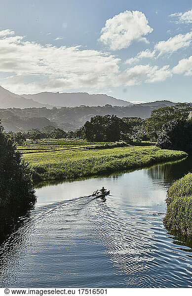Man paddling in a canoe on Hanalei River