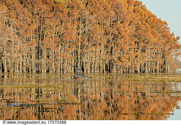 man paddling to find fish in fall