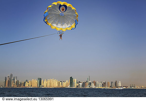 Man parasailing against clear sky