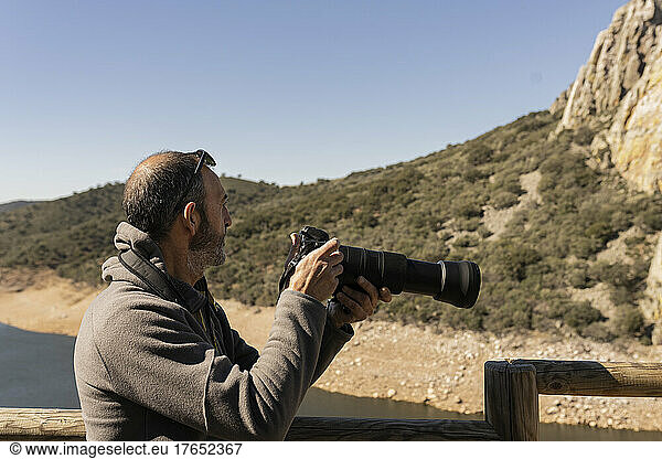 Man photographing birds in Monfrague National Park