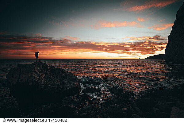 Man photographing the sunset in Spain
