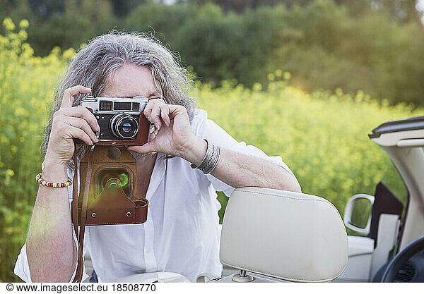 Man photographing with old school vintage camera  Bavaria  Germany