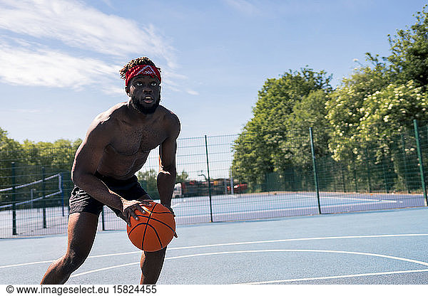 Man playing basketball and looking up