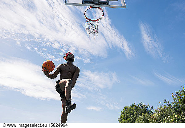 Man playing basketball  dunking