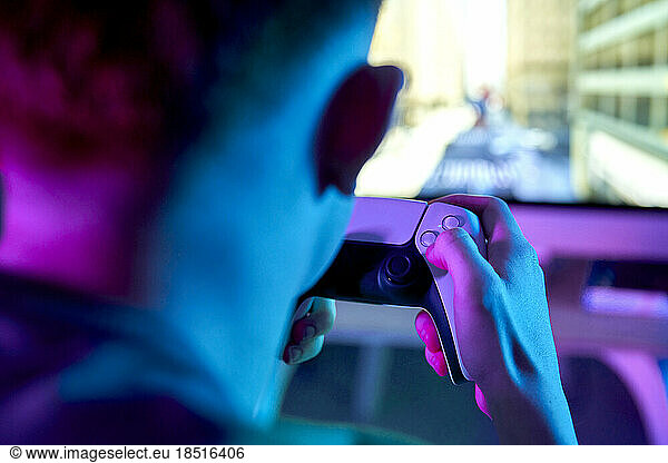 Man playing leisure game in front of screen