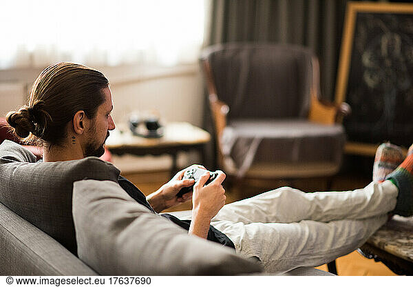 Man playing video game at home
