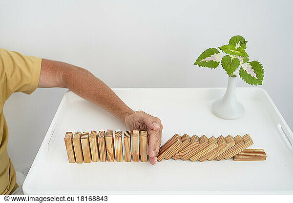 Man playing with toy blocks on coffee table