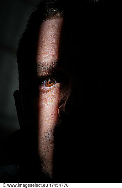 man portrait hiding in the shadows