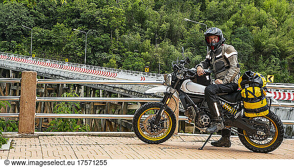 man posing on his motorbike in the North of Thailand