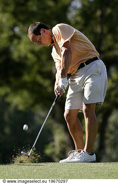 Man practicing golf swing.