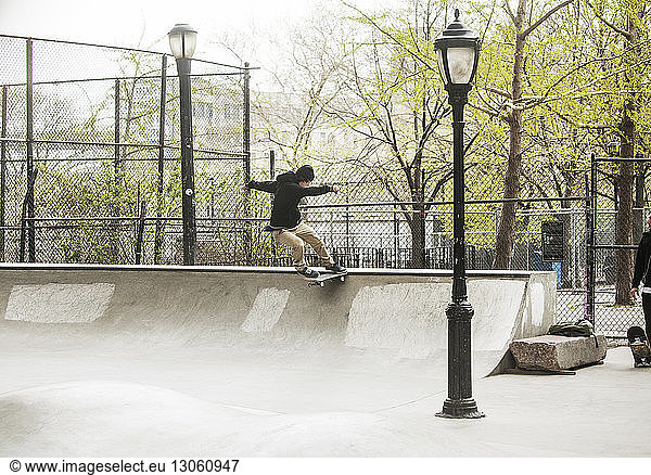 Man practicing skateboarding at skateboard park