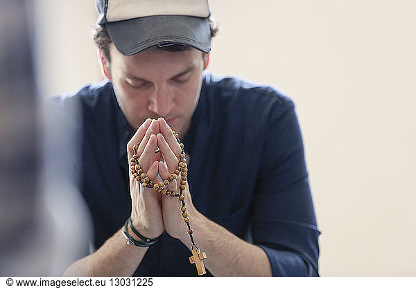 Man praying with rosary