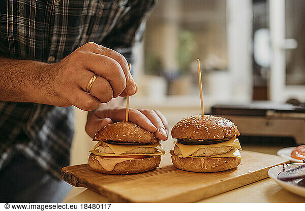 Man preparing burger at home