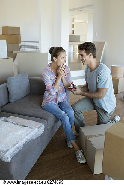 Man proposing to girlfriend in new house