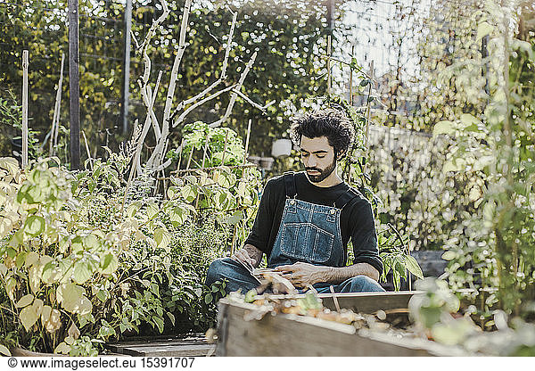 Man reading book in urban garden
