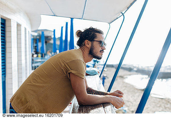Man relaxing under canopy at sea  Livorno  Italy