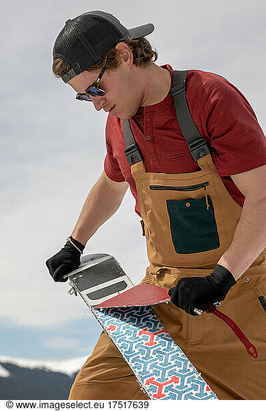 Man removes skins from splitboard in the Colorado Backcountry