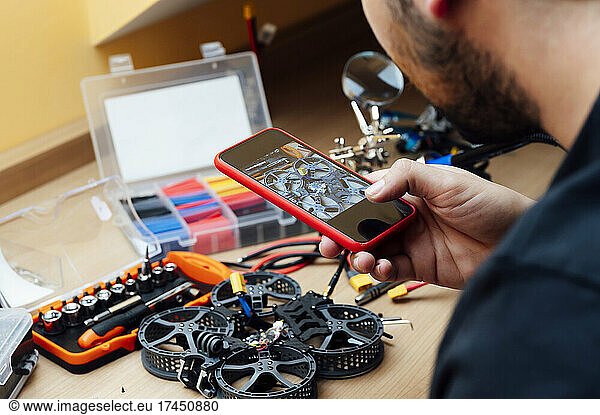 Man Repair A Drone.Engineer repairs a drone at home