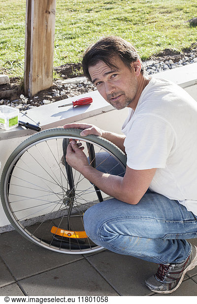 Man repairing bicycle wheel