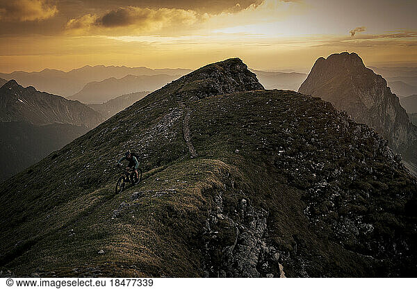 Man riding mountain bike on summit