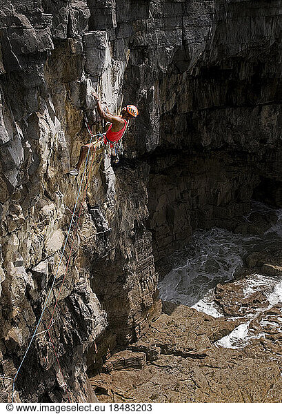 Man rock climbing on sunny day  Pembrokeshire  Wales