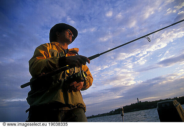 Man salt water fishing for Striper  Maine  New England.