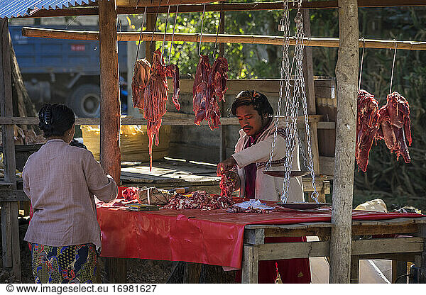 Man selling meat on street market in village  Lake Inle  Nyaungs