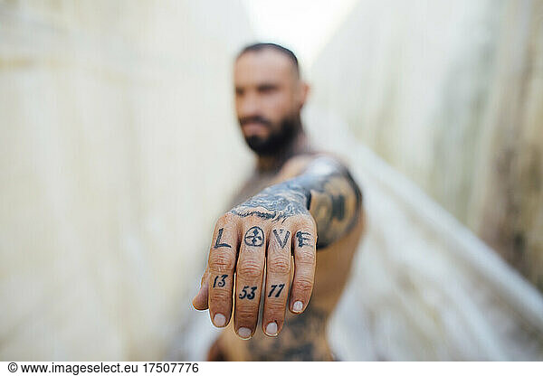 Man showing tattooed hand