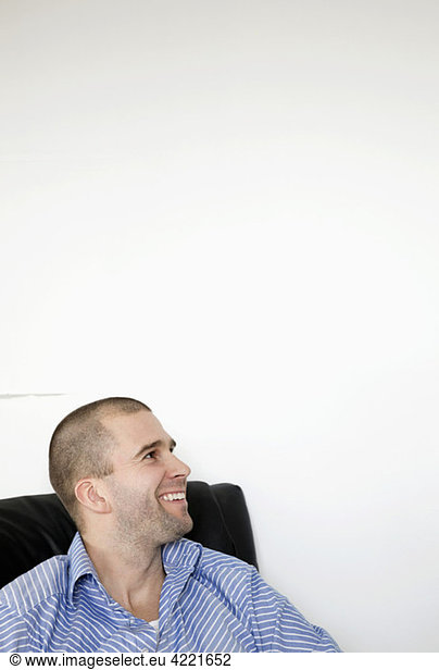 Man sitting in armchair smiling