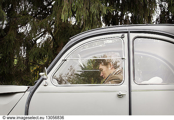 Man sitting in vintage car