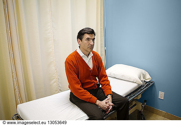 Man sitting on hospital gurney