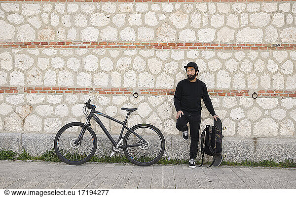 Man Skateboarder with a bike Lifestyle Hipster Concept