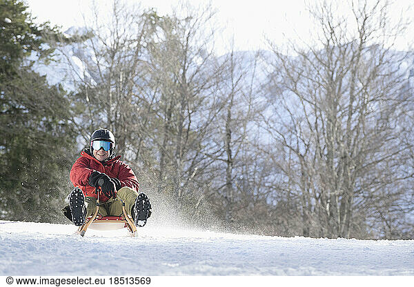 Man sliding on sledge  Tyrol  Austria