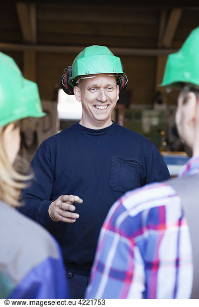 Man speaking with colleagues