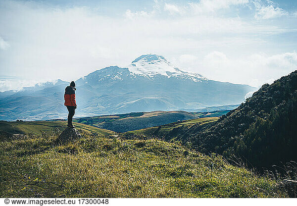 Man standing in front of Cayambe volcano with a beautiful view