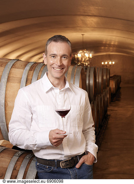 Man Standing in Wine Cellar