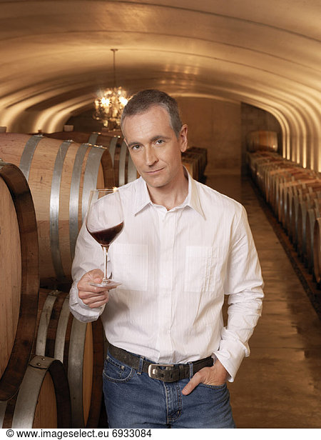 Man Standing in Wine Cellar