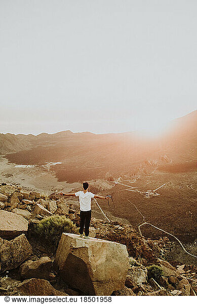 Man standing on rock watching sunset at caldera of Cañadas del Teide