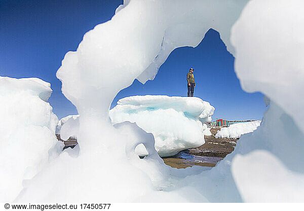 Man standing on sea ice chunk  Iqaluit  Canada.