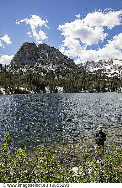Man standing on shore of Crystal Lake  Mammoth Lakes  California  USA