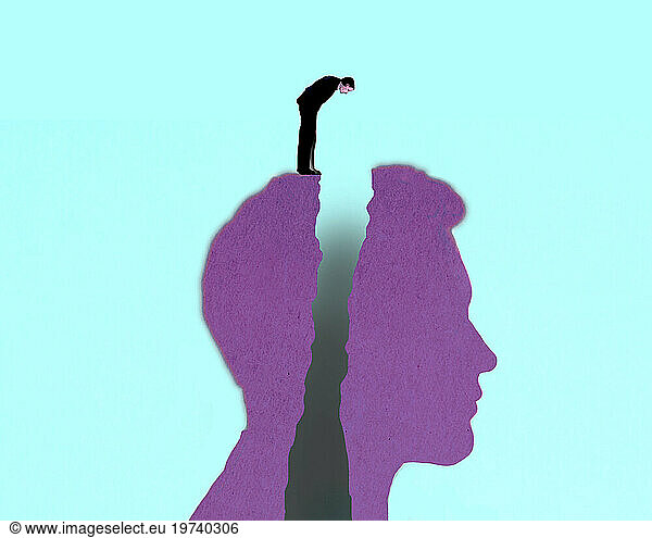 Man standing on top of large split head