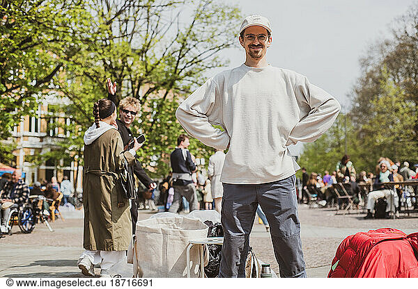 man stands happy and proud at second hand flee market in europe