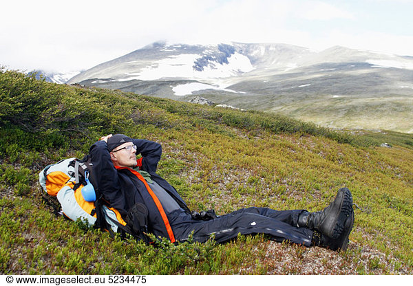 Man taking a break in mountains