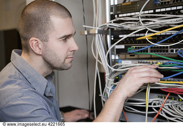 Man taking care of network cables