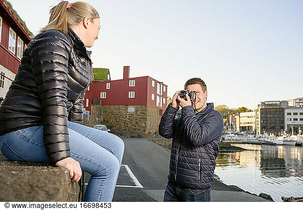 Man taking photo of woman in historic city