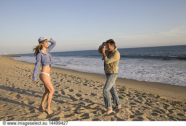 Man Taking Photo of Woman on Beach I